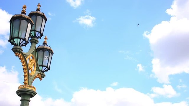 Close-Up Of Street Lamp On Westminster Bridge And The Helicopter Over The London City