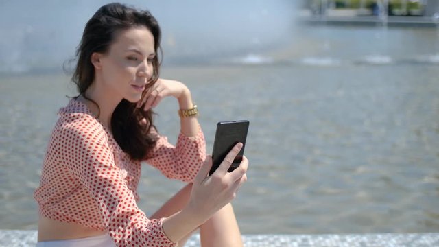 Pretty and sexy girl takin a selfie photo with her mobile phone