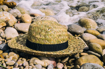 Summer straw hat on the beach
