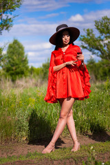 Happy young asian woman in hat on a nature 