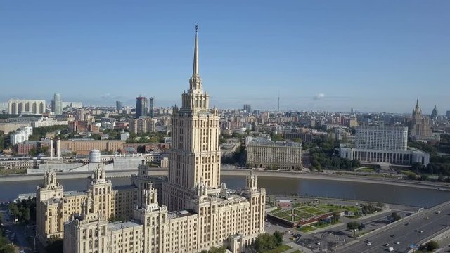 Aerial view of hotel Ukraine in Moscow. Old Soviet Russia Stalin high-rise skyscrapers in heart of modern Moscow City. Kutuzov avenue day traffic.