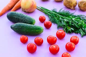 Different vegetables on purple background.