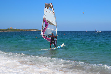 Windsurfing in the beautiful backdrop of Sardinia (Vignola, Italy)