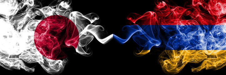 Japan vs Armenia, Armenian smoky mystic flags placed side by side. Thick colored silky smokes combination of Armenia, Armenian and Japanese flag