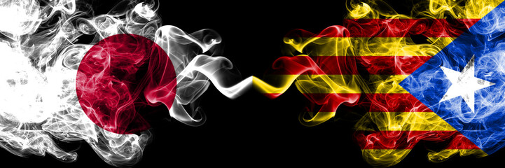 Japan vs Catalonia, Spain smoky mystic flags placed side by side. Thick colored silky smokes combination of Catalonia, Spain and Japanese flag