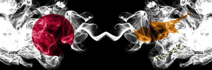 Obraz premium Japan vs Cyprus, Cyprian smoky mystic flags placed side by side. Thick colored silky smokes combination of Cyprus, Cyprian and Japanese flag