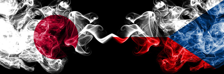 Japan vs Czech Republic smoky mystic flags placed side by side. Thick colored silky smokes combination of Czech Republic and Japanese flag