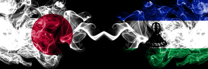 Japan vs Lesotho smoky mystic flags placed side by side. Thick colored silky smokes combination of Lesotho and Japanese flag
