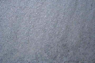A surface of a architectural stone.(white, gray, purple and sparkling. rough)