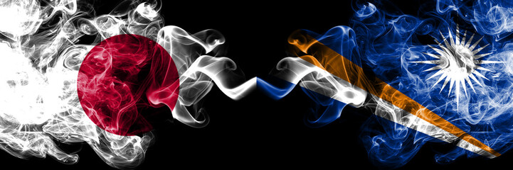 Japan vs Marshall Islands smoky mystic flags placed side by side. Thick colored silky smokes combination of Marshall Islands and Japanese flag