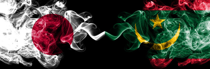 Japan vs Mauritania, Mauritanian smoky mystic flags placed side by side. Thick colored silky smokes combination of Mauritania, Mauritanian and Japanese flag