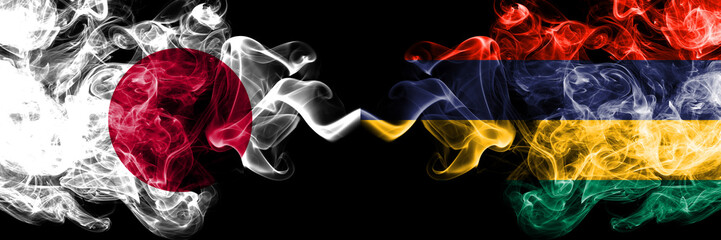 Japan vs Mauritius, Mauritian smoky mystic flags placed side by side. Thick colored silky smokes combination of Mauritius, Mauritian and Japanese flag