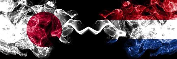 Japan vs Netherlands, Dutch smoky mystic flags placed side by side. Thick colored silky smokes combination of Netherlands, Dutch and Japanese flag