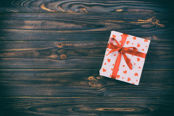 Valentine or other holiday handmade present in paper with red hearts and gifts box in holiday...