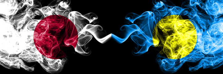 Japan vs Palau, Palaulan smoky mystic flags placed side by side. Thick colored silky smokes combination of Palau, Palaulan and Japanese flag