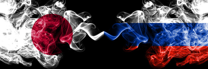 Japan vs Russia, Russian smoky mystic flags placed side by side. Thick colored silky smokes combination of Russia, Russian and Japanese flag
