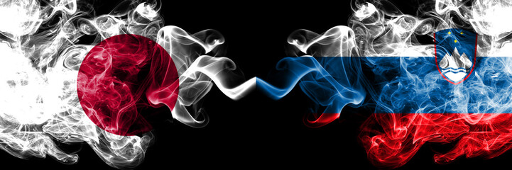 Japan vs Slovenia, Slovenian smoky mystic flags placed side by side. Thick colored silky smokes combination of Slovenia, Slovenian and Japanese flag