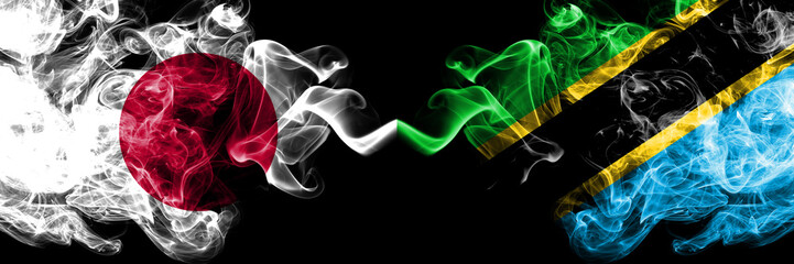 Japan vs Tanzania, Tanzanian smoky mystic flags placed side by side. Thick colored silky smokes combination of Tanzania, Tanzanian and Japanese flag