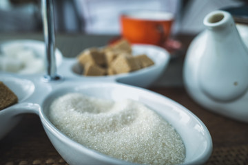 Different types of sugar on the table on the teapot background