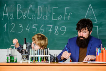 confidence & charisma. Back to school. Science chemistry concept. father and son at school. bearded man teacher with little boy. Pupil kid in the chemistry class. Education the solution to violence