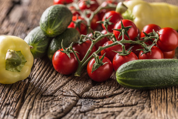 Fresh tomatoes cucumber and pepper on wooden table