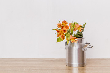 Bunch of flowers in milk can