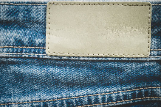 Empty leather label on jeans background with copy space