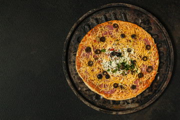 pizza, raw ingredients (frozen dough, olives, meat, sausages, tomato, cheese). Top view. copy space