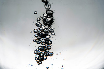 swirl of bubbles in the water. monochrome background.