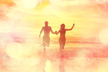 Fototapeta premium lovers run along the beach / guy and girl run along the summer sea beach, rest on the sea honeymoon