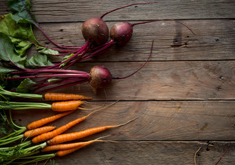 A bunch of carrots and beetroots . Fresh carrots, beetroot  heap with green stems. Raw Carrots on...