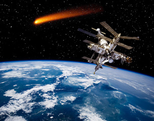 Space station above the earth. Comets. The elements of this image furnished by NASA.