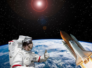 Astronaut and rocket above the earth. Space concept. The elements of this image furnished by NASA.