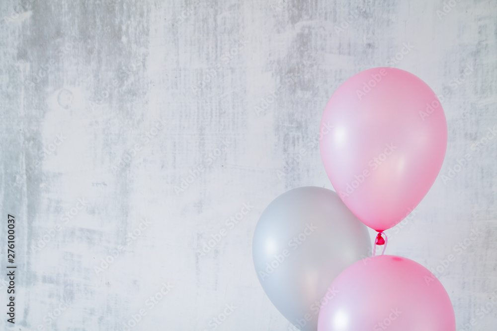 Wall mural pink and gray balloons for birthday party on gray concret background with a copy space