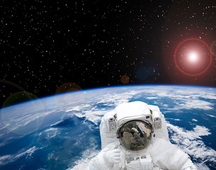 Fascinating earth and astronaut flying in outer space. The elements of this image furnished by NASA. © wowinside