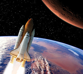 Rocket above earth. Mars in the distance. The elements of this image furnished by NASA.