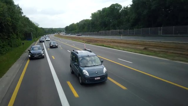 Paris, France - Brussels, Belgium - June 2019: Time lapse, cars driving on the highway.
