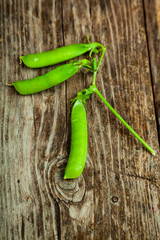 Pea pods on a wooden background.