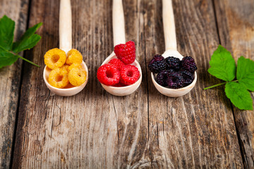Ripe raspberry on an old wooden table.