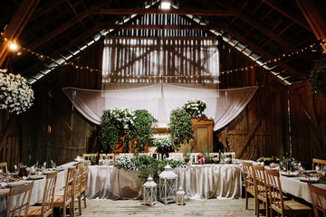 Interior of an old wooden hall with decorated tables.