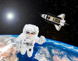 Space shuttle is going on mission. Astronaut in the outer space. The elements of this image...