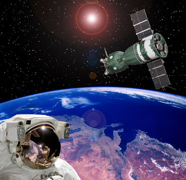 Astronaut staring at the spaceship. Scene above earth. The elements of this image furnished by NASA.