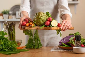 Girl holding fresh vegetables. The concept of losing healthy and wholesome food, detox, vegan eating, diet, cooking. Slow food, comfort food, healthy diet, clean eating, horizontal photo