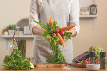 Girl holding fresh vegetables. The concept of losing healthy and wholesome food, detox, vegan eating, diet, cooking. Slow food, comfort food, healthy diet, clean eating, horizontal photo