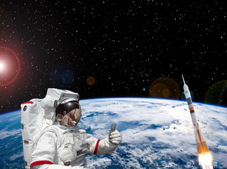 Astronaut and rocket above the earth. Space concept. The elements of this image furnished by NASA.
