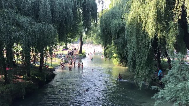 MUNICH, GERMANY - August 2018: Abnormal heat in the city. The residents of Munich city bathe in the river in hot weather.