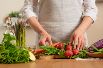Girl holding fresh vegetables. The concept of losing healthy and wholesome food, detox, vegan eating, diet, cooking. Slow food, comfort food, healthy diet, clean eating, horizontal photo