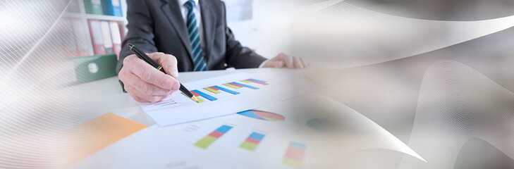 Businessman analyzing graphs; panoramic banner