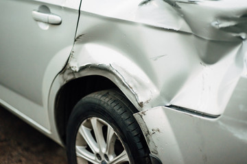 dents on the car door caused by an accident on the road