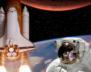 Rocket flies from earth to Mars. Astronaut in outer space. The elements of this image furnished by...